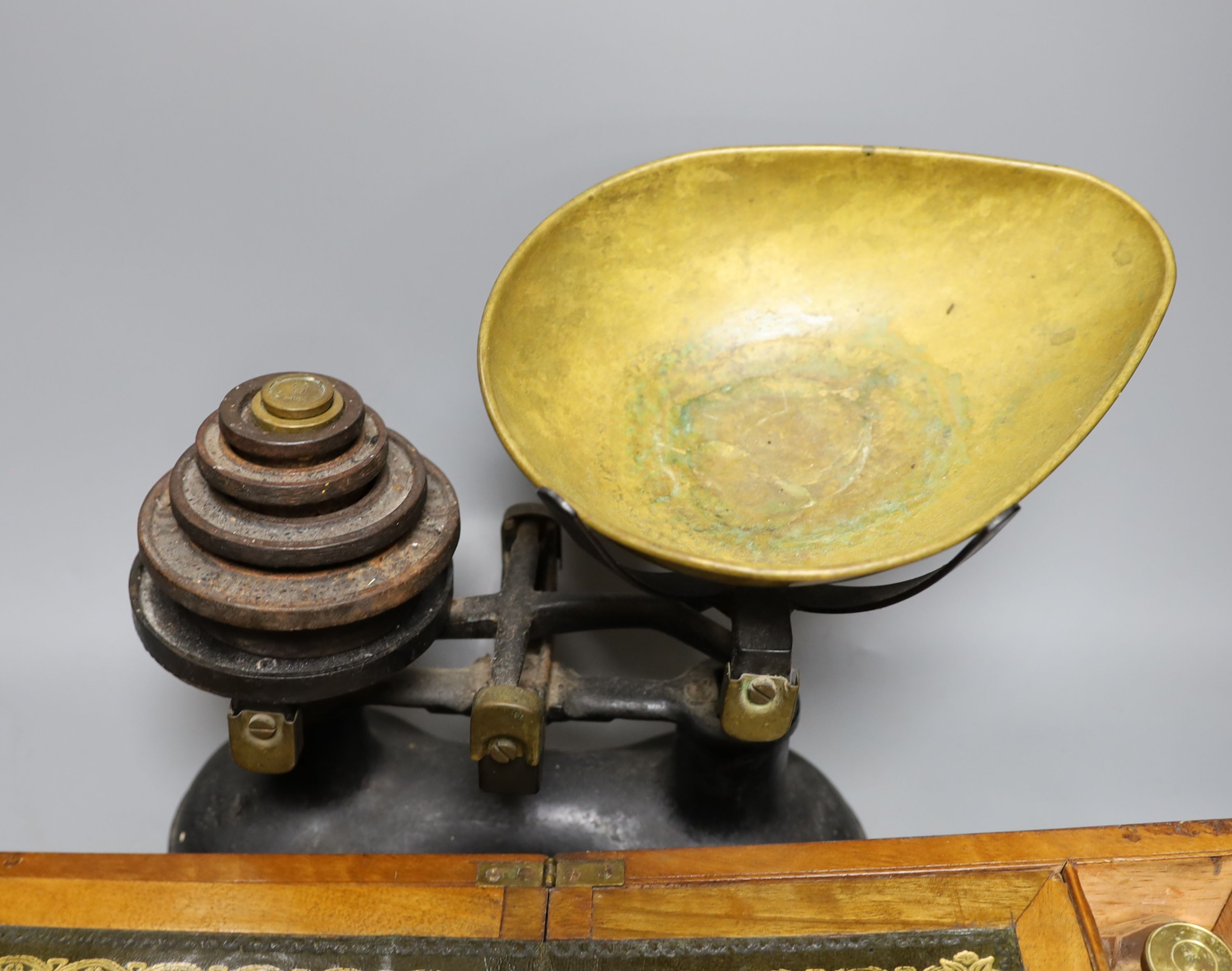 A Victorian walnut writing slope and a set of Victorian cast iron scales and weights (2), writing box 30 cms wide x14 cms high.